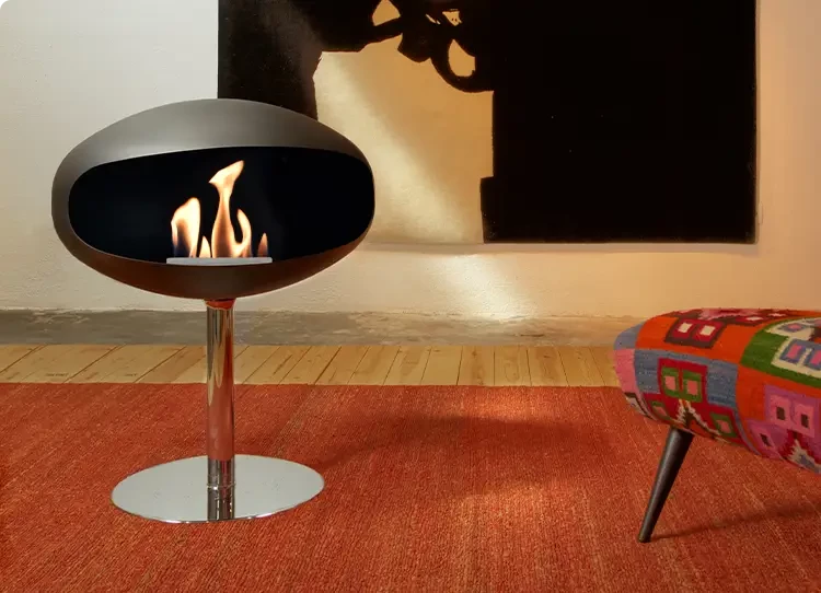 Little boy in front of a bioethanol fireplace